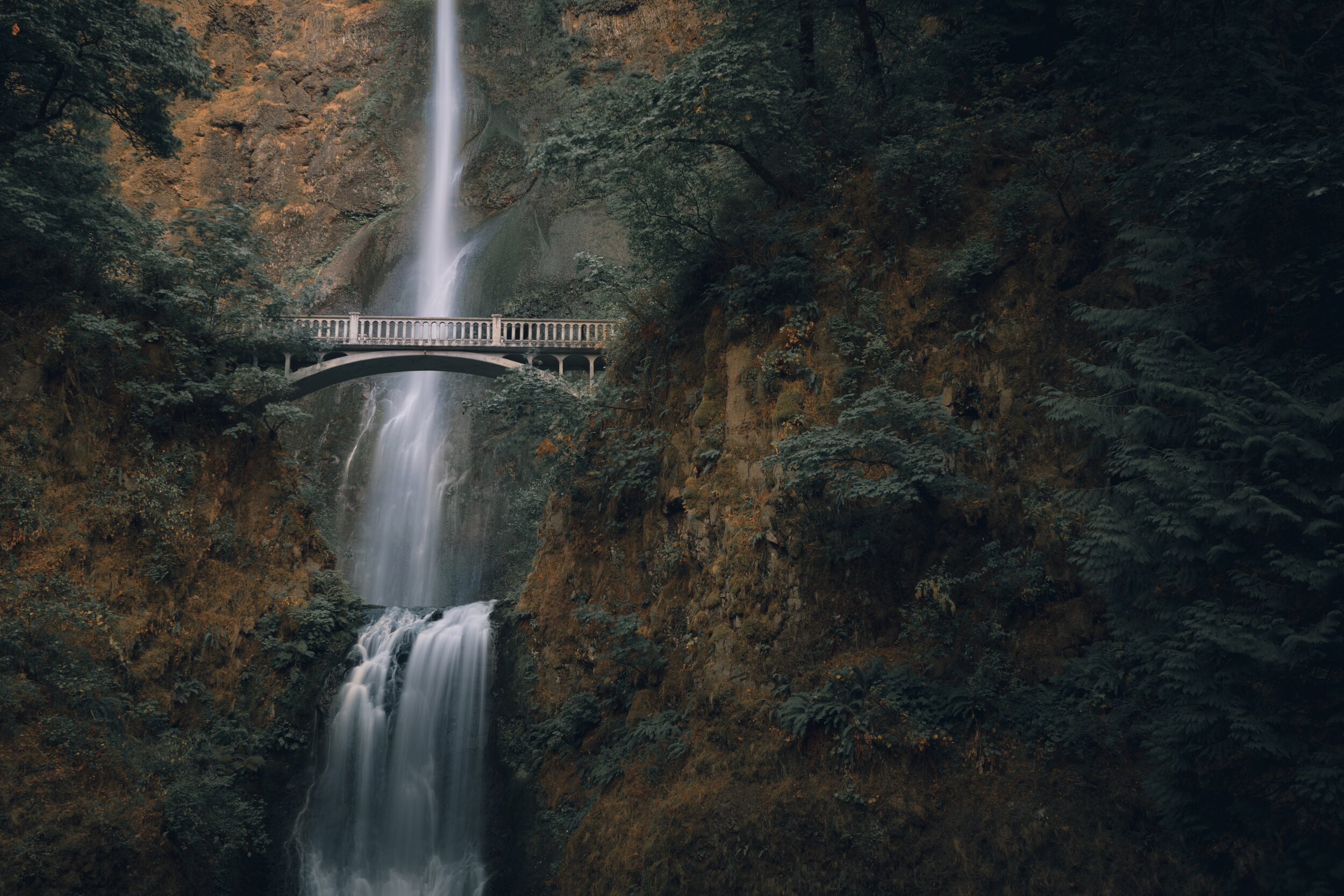 bridge across a waterfall